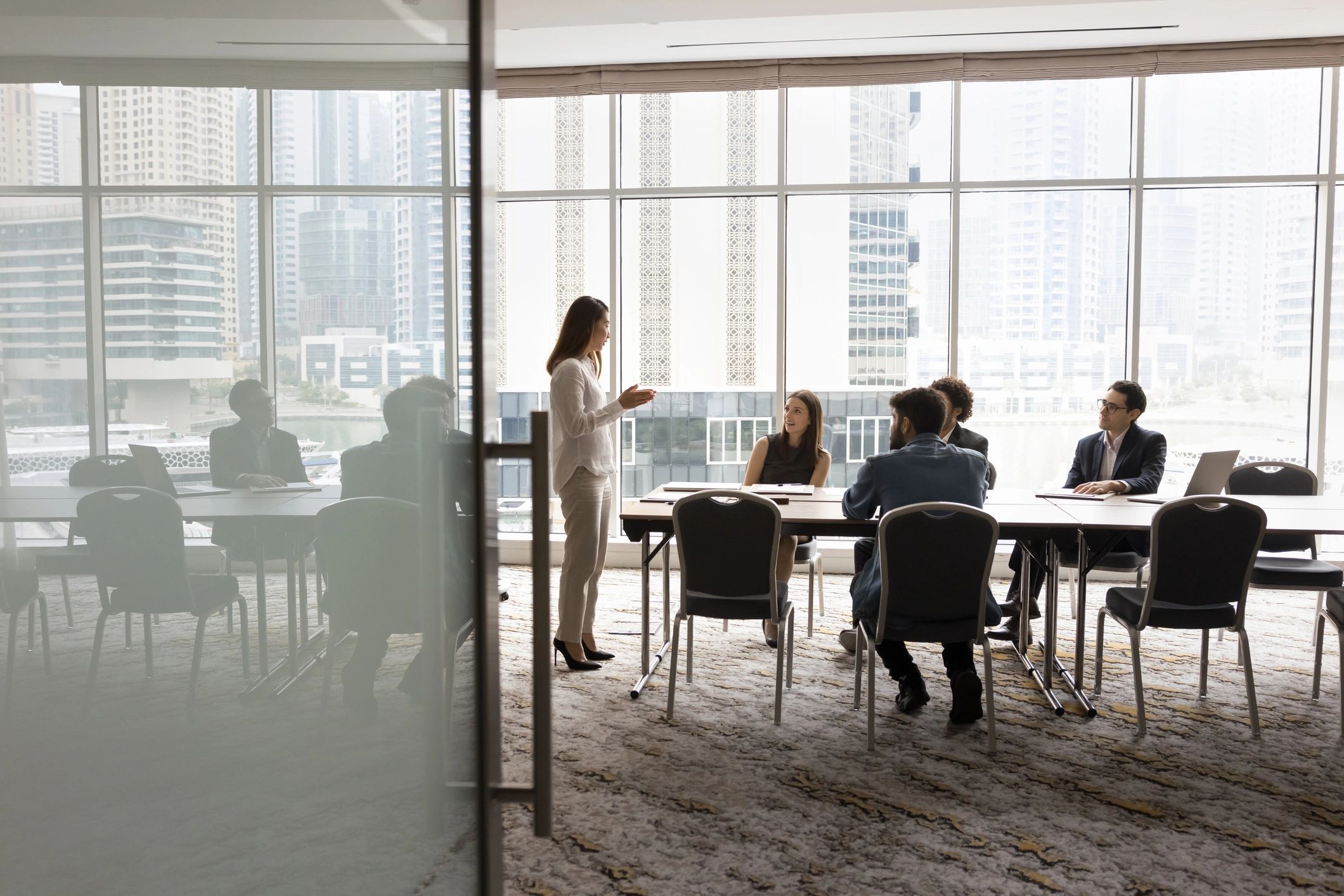 Wide shot of multiethnic business team talking at meeting table